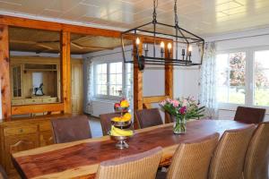 a dining room with a wooden table and chairs at Haus Caroline in Hallschlag