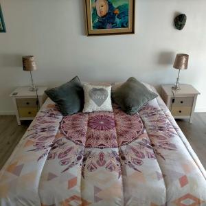 a bedroom with a bed with two nightstands and two lamps at Alaric Lodge: gîte champêtre avec parking privé. in Comigne