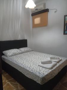 a small bedroom with a bed with a lamp on it at Efi in Kato Alepochori