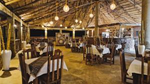 a restaurant with tables and chairs in a room at Africa Safari Karatu in Karatu