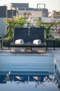 a bench sitting next to a pool on a rooftop at Silken Ramblas in Barcelona