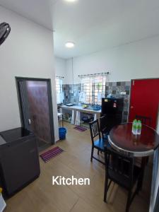 a living room with a table and a kitchen at 4A Home2Stay in Kota Bharu