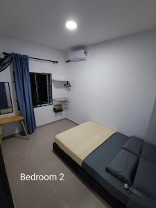 a bedroom with a bed and a television in it at 4A Home2Stay in Kota Bharu