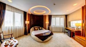 a large room with a bed and a desk and window at Bera Konya Hotel in Konya +95 photos