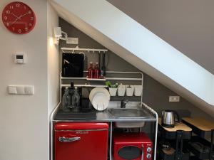 a kitchen under the stairs with a sink at Cozy friendly place with free parking in Prague