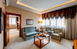 a living room with two chairs and a table at Bera Konya Hotel in Konya