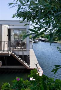 a house on a river with a dock at Villa Nautica Kortgene in Kortgene
