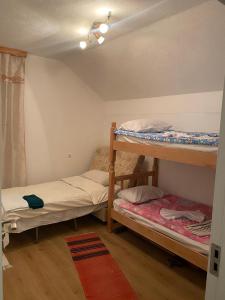 a room with two bunk beds and a rug at Guesthouse GS 84326 in Gusinje