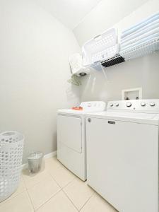 a laundry room with a washer and dryer at Gone 2 Florida Vacation Homes in Orlando