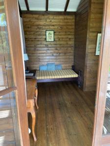 a sauna with a bench in a wooden room at Bungalow à flanc de colline in Le Morne Rouge