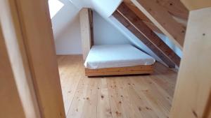 a small room with a bed in the attic at Zum Eichbühl in St. Blasien