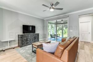 a living room with a couch and a tv at 632 Palmetto Place - Wildlight home in Yulee