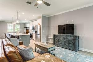 a living room with a couch and a tv at 632 Palmetto Place - Wildlight home in Yulee