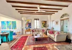 a living room with couches and a table at Castel Horizon - Super Cannes - 360 Degrees View in Vallauris