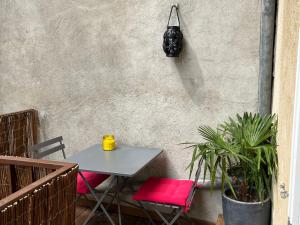 a table and two chairs on a patio at La terrasse de Dupuy,appartement climatisé in Toulouse