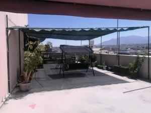 a patio with awning on top of a building at Hotel La Mansion Del Sol in Arequipa