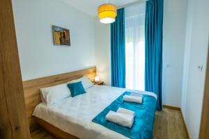 Llit o llits en una habitació de Pini Apart-hotel