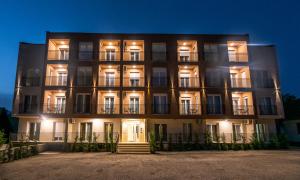 a large building with lights on it at night at Pini Apart-hotel in Kolašin
