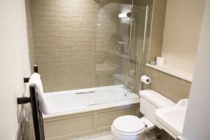 a bathroom with a shower and a toilet and a sink at Alvanley Arms, Cotebrook in Tarporley