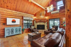 a living room with leather furniture and a fireplace at Rocky Mountain in New Braunfels