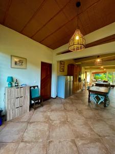 a large living room with a ping pong table in it at Chambre Ylang Ylang vue Mont Pelée in Le Morne Rouge