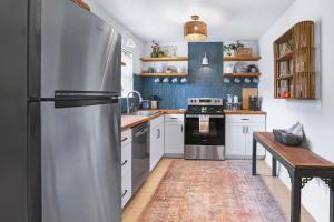 a kitchen with a stainless steel refrigerator and a table at Lily Pad in Wimberley