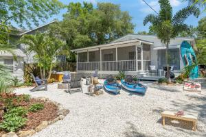 a backyard with a house with a pool at Catch the Breeze on Crystal Beach in Palm Harbor