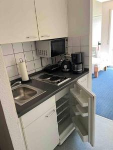 a kitchen with a sink and a stove top oven at FMA Ferienwohnung GD in Schwäbisch Gmünd