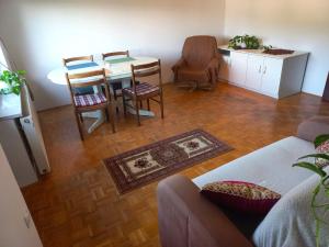 a living room with a couch and a table and chairs at Homestay Zajec in Grosuplje