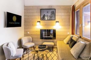 a living room with a couch and chairs and a tv at Residence Plagne Lauze - maeva Home in Plagne 1800