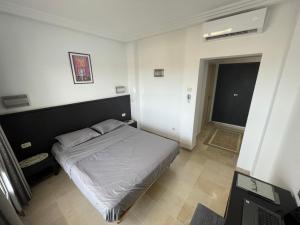 a bedroom with a bed in a room at Beachfront Apartment 105- Hotel Andalucia in Bizerte