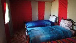 A bed or beds in a room at Chegaga Desert Trips