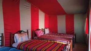A bed or beds in a room at Chegaga Desert Trips
