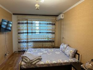 a small bedroom with a bed with a window at Квартира з видом на Дніпро in Cherkasy