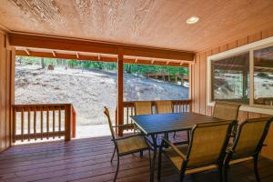 a dining room with a table and chairs on a porch at Groveland Vacation Rental Near Pine Mountain Lake! in Groveland