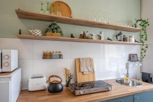 a kitchen with a sink and a counter top at Wohlfühlwohnung mit 25 qm Terrasse, Netflix in Koblenz