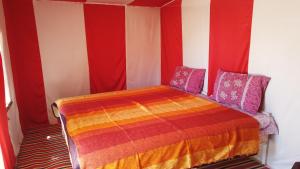 A bed or beds in a room at Chegaga Desert Trips