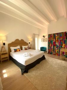 a bedroom with a large bed in a room at Hotel Maïa in Ciutadella