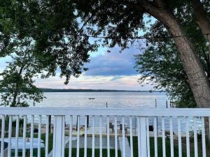 a white fence with a view of the water at Waterfront Home with Private Beach, Stunning Views in Middle River
