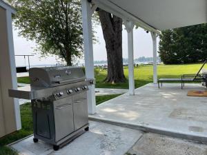 a grill on a patio under a pavilion at Waterfront Home with Private Beach, Stunning Views in Middle River