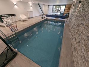 a swimming pool with a basketball hoop in a building at CHEZ ANITA 