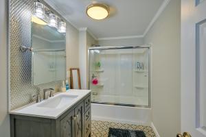 a white bathroom with a shower and a sink at Weymouth Waterfront Getaway with Swim Spa and Hot Tub in Weymouth +27 photos
