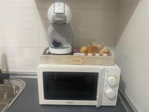 a white microwave with a bowl on top of it at Apartamento en Toledo ideal para visitas a Puy du Fou in Toledo
