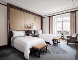 Un ou plusieurs lits dans un hébergement de l'établissement The Peninsula Paris