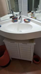 a bathroom with a white sink and a mirror at studio plage de l'anse caritan in Sainte-Anne