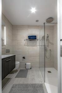 a bathroom with a shower and a toilet and a sink at Luxury 2bedroom apartment on San Juan Beach in Playa de San Juan