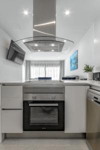a kitchen with a stove top oven in a kitchen at Luxury 2bedroom apartment on San Juan Beach in Playa de San Juan