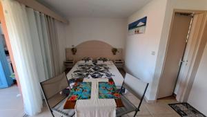 a room with four tables and chairs in it at studio plage de l'anse caritan in Sainte-Anne