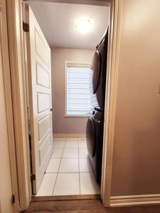 a hallway with a door open to a laundry room at Cozy 4 bedrooms home Milton in Milton