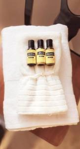 two bottles of essential oils sitting on a white towel at Cozy 4 bedrooms home Milton in Milton
